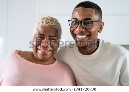 Happy smiling Hispanic mother and son portrait - Family love and unity concept 