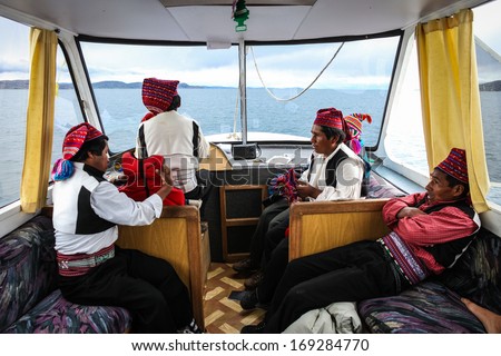TAQUILE ISLAND, PERU - JANUARY 18: Quechua men travel on a boat from Taquile island to Puno, Peru on January 18, 2010. Puno is a tourist destination on the shores of Lake Titicaca.