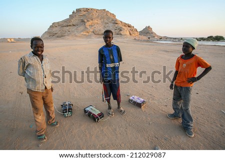 WADI HALFA, SUDAN - OCTOBER 30: Unidentified boys play with home made boxes as toys on October 30, 2007 in Wadi Halfa, Sudan.