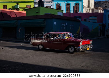 HAVANA, CUBA - MAR 13: Old taxi car in a street scene in Havana on 13 March 2011 in Havana, Cuba.