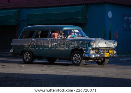 HAVANA, CUBA - MAR 13: Old taxi car in a street scene in Havana on 13 March 2011 in Havana, Cuba.