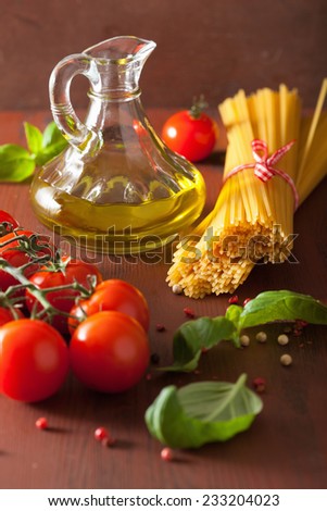 raw pasta olive oil tomatoes. italian cooking in rustic kitchen