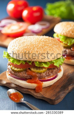 burger with beef patty lettuce onion tomato ketchup