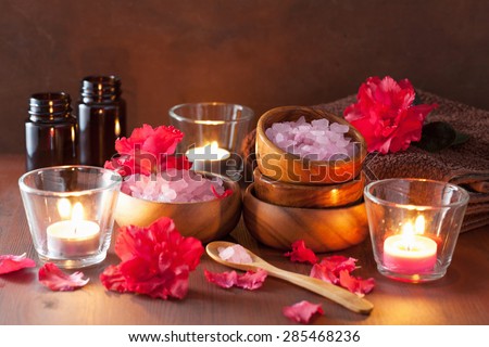 spa aromatherapy with azalea flowers and herbal salt on rustic dark background