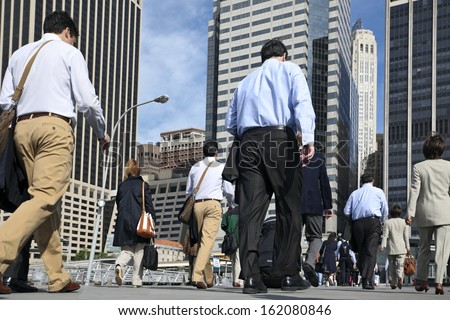 business people at rush hour walking in the street