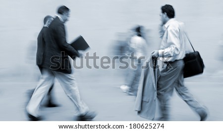 abstrakt image of business people in the street and modern style with a blurred background and blue tonality