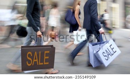 people shopping in the city in motion blur