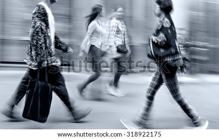 people shopping in the city in motion blur and monochrome blue tonality