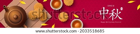 Mooncake on bamboo mat and teacup on red background, Chinese translation is blessing and Mid Autumn. Top view of tea ceremony with cookies, China holiday festival poster design.