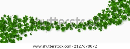 Green flying clover leaves isolated on white background. Vector illustration. Spring decoration for Saint Patrick's day border or frame design