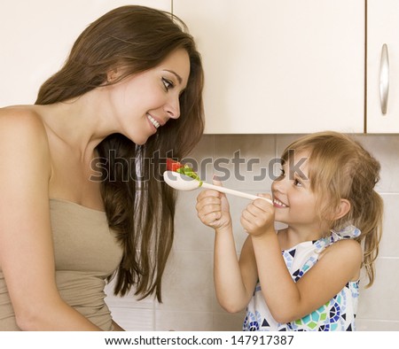 daughter feeding mother - picture of mother and daughter eat healthy food