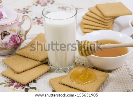 glass of buttermilk (milk) and cookies with honey
