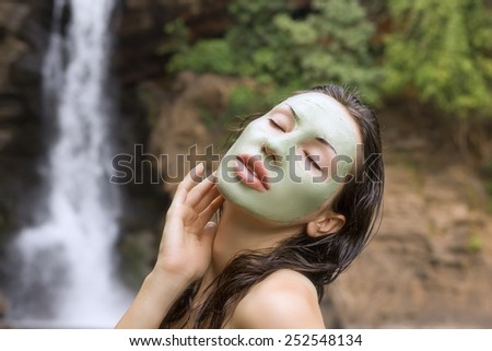 Spa Outdoor, Beautiful young woman lying with natural green herbal facial mask on her face
