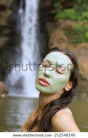 Spa Outdoor, Beautiful young woman lying with natural herbal facial mask on her face