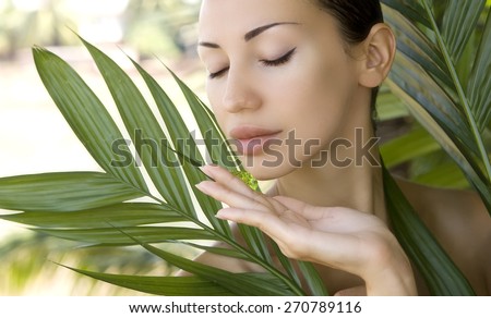 Beautiful caucasian woman holding natural aloe vera facial gel, skin care and wellness. Facial moisturize mask, spa salon outdoors.