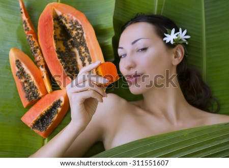 Beautiful caucasian woman with fresh fruit papaya (outdoors). Healthy Natural Exotic Food, Luxury Rest in the Tropical countries of Asia