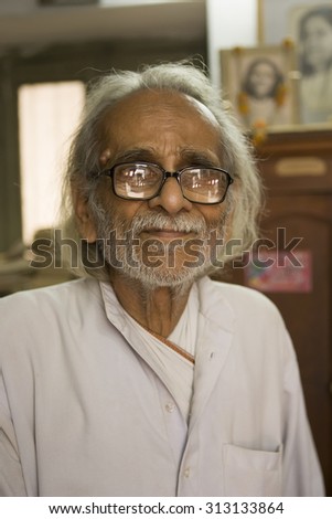VARANASI, INDIA, Jan 9, 2015: Unidentified indian old Man in his Book Shop (library) on Jan 9, 2015, Varanasi, India. According to legend, Varanasi was founded by Lord Shiva.
