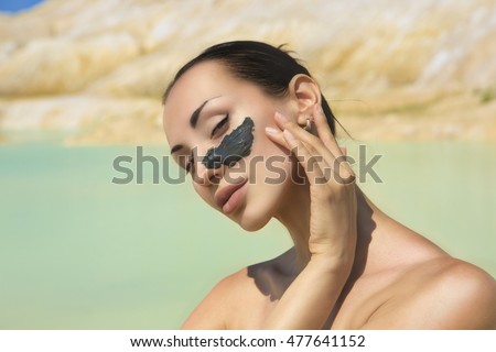 Similar – Image, Stock Photo Relaxed woman applies mineral clay mask on face for rejuvenation, has headband on head