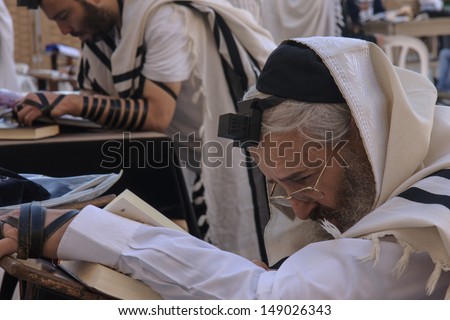 JERUSALEM - JULY 31 - Orthodox Jews prays at the Western Wall - July 31, 2013 in the old city of Jerusalem, Israel. The western wall is the holiest place in Jewish tradition