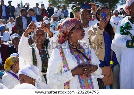 JERUSALEM - NOV 20, 2014: Ethiopian Jewish women mix old tradition of prays, with modern documentation devices, at the Sigd, in Jerusalem, Israel. The Sigd is an annual holiday of the Ethiopian Jews