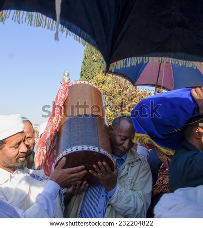 JERUSALEM - NOV 20, 2014: An Ethiopian Jewish man and a Kes, religious leader of the Ethiopian Jews, carrying the holy torah book, at the end of the annual Sigd holiday prays, in Jerusalem, Israel