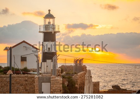 The lighthouse, at sunset, in the old city of Acre, Israel