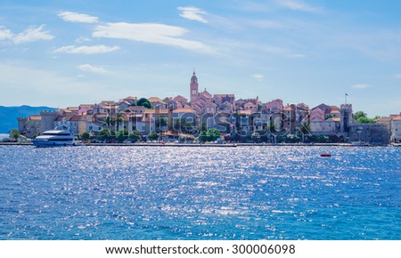 KORCULA, CROATIA - JUNE 26, 2015: Scene in the old town (west side), with the walls, houses, boats, locals and visitors, in Korcula, Croatia