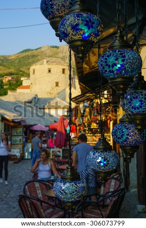 MOSTAR, BIH - JULY 05, 2015: Scene of the old city, with local businesses, locals and tourists, in Mostar, Bosnia and Herzegovina
