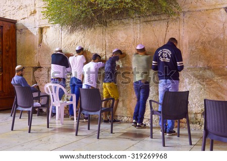 JERUSALEM, ISRAEL - SEPTEMBER 21, 2015: Jewish men pray Selichot (Jewish penitential prays) in the western wall, in the old city of Jerusalem, Israel