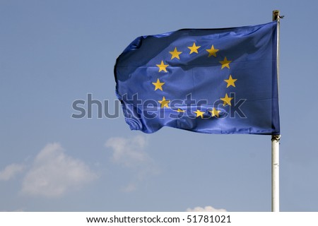 Waving blue flag of Europe Union against blue sky