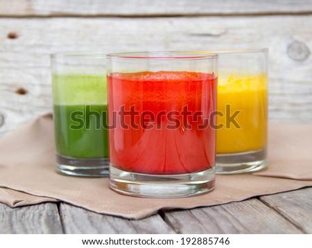 Fresh smoothies in the glass - green, red and yellow paprika