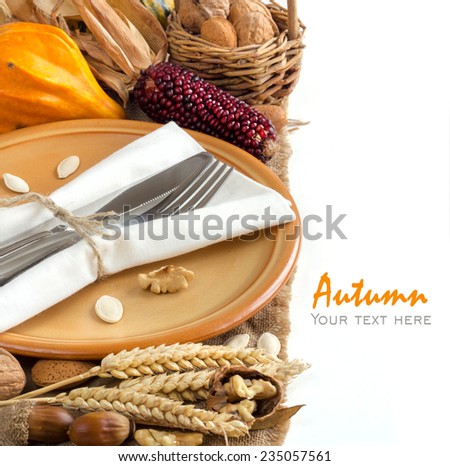 Autumn table setting with corn, nuts and pumpkins