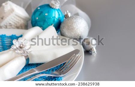 Turquoise and silver Christmas ornaments border on silver background