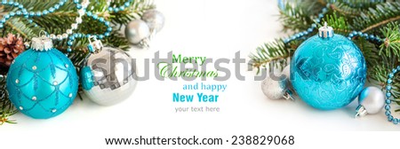 Turquoise and silver Christmas ornaments on white background