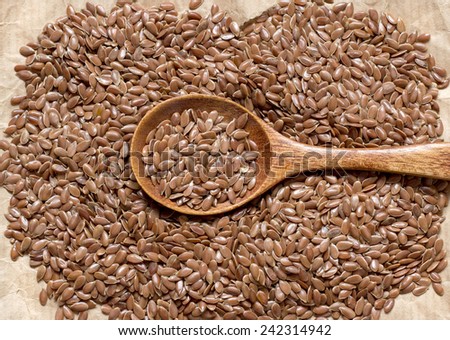 Pile of flax seeds on acraft paper background