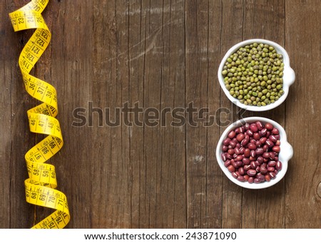 Raw Organic azuki and mung beans in bowls on wooden table
