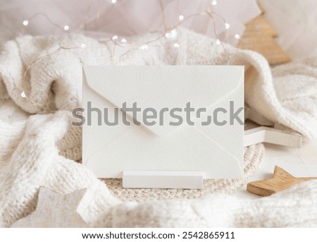 Similar – Image, Stock Photo Blank envelope near pastel pom-poms on light blue top view