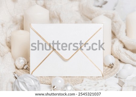 Image, Stock Photo Blank envelope near pastel pom-poms on light blue top view