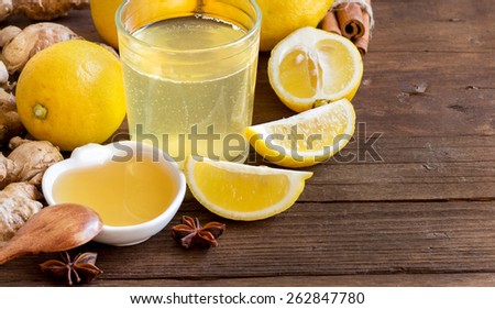 Honey, lemon, ginger tonic and ingridients on wood