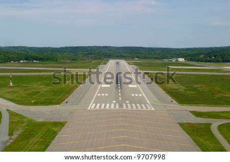 Airport runway on landing approach. Taken from cockpit of small private plane.