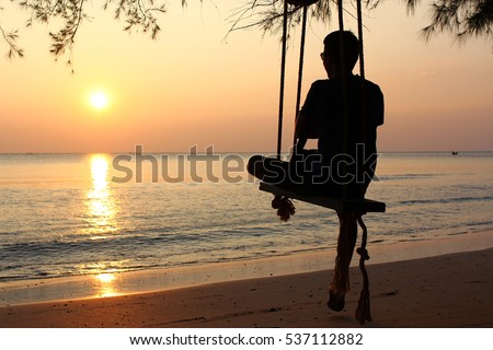 https://image.shutterstock.com/display_pic_with_logo/164679746/537112882/stock-photo-man-alone-hugging-knees-while-swing-on-the-beach-see-at-sunset-537112882.jpg