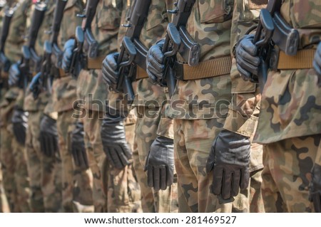 Army parade - armed soldiers in camouflage military uniform
