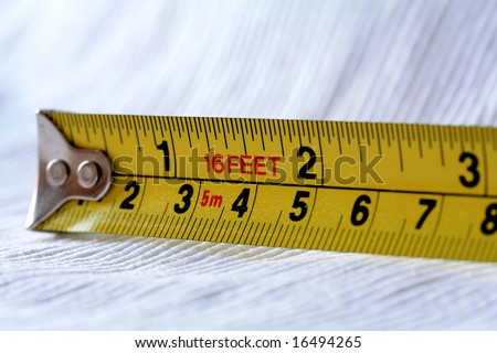 A 16 Feet Yellow Tape Measure with Inches and Centimetres