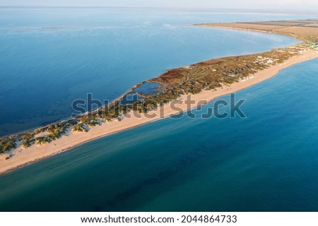 Similar – Foto Bild Sandstrand zwischen langen Klippen am Meer