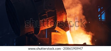 Metal pouring with sparks. Smelting of cast iron parts in foundry. Metallurgical plant or Steel Mill ストックフォト © 