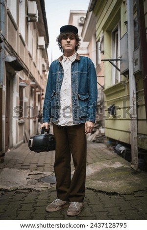 Similar – Image, Stock Photo Urban stylish young man standing by the wall using cellphone