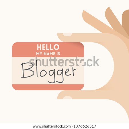 Human hand holding card with text Hello, I am Blogger. Concepts: online blogging, social media services, internet relationships, social networking, journalism and news.