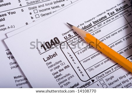 Individual income tax forms from the United States with a pencil on top