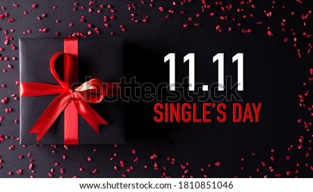 Online shopping of China, 11.11 singles day sale concept. Top view of black christmas boxes with red ribbon on black background with copy space for text 11.11 singles day sale. Foto stock © 