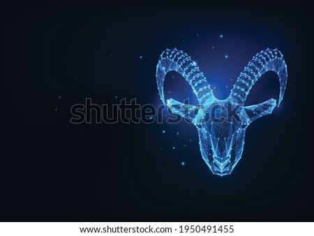 Futuristic glowing low polygonal goat, mouflon protrait, capricorn isolated on dark blue